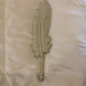 Like new off white cast iron feather hook.